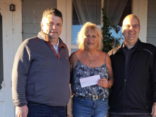 Bonnie 'Bon Bon' Lamont with Emerald Community Centre Manager Kent Croken and PEI Darts Association President Stephen Clow presenting Bonnie her winnings