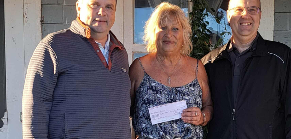 Bonnie 'Bon Bon' Lamont with Emerald Community Centre Manager Kent Croken and PEI Darts Association President Stephen Clow presenting Bonnie her winnings